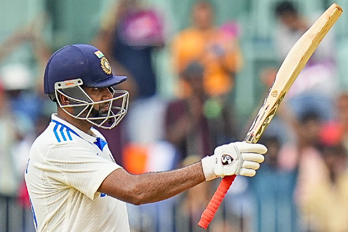 Ravichandran Ashwin raising his bat after scoring a hundred.